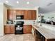 Open-concept kitchen with stainless steel appliances, light countertops, and seamless connection to the living area at 16145 Amethyst Key Dr, Wimauma, FL 33598