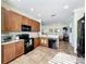 Spacious kitchen boasting stainless steel appliances, light countertops, and easy access to the dining and living areas at 16145 Amethyst Key Dr, Wimauma, FL 33598