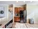 Modern kitchen area equipped with stainless steel appliances, ample cabinet space, and a sleek refrigerator at 16145 Amethyst Key Dr, Wimauma, FL 33598