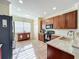Well-lit kitchen featuring stainless steel appliances, light countertops, and ample cabinet space for efficient cooking at 16145 Amethyst Key Dr, Wimauma, FL 33598