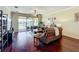 Inviting living room with hardwood floors, comfortable seating, and a view of the lake creating a relaxing ambiance at 16145 Amethyst Key Dr, Wimauma, FL 33598
