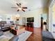 Spacious living room boasts gleaming hardwood floors and an open floor plan great for entertaining at 16145 Amethyst Key Dr, Wimauma, FL 33598
