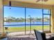 Relaxing screened-in patio overlooking a serene lake at 16145 Amethyst Key Dr, Wimauma, FL 33598
