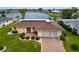 Aerial view of the home showcasing the large front lawn, driveway, and landscaping at 1710 New Bedford Dr, Sun City Center, FL 33573