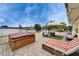 Backyard patio with outdoor seating, firepit, and hot tub with a view of the water at 1710 New Bedford Dr, Sun City Center, FL 33573