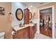 Bathroom with double sinks, granite counters, and wood cabinets providing style and functionality at 1710 New Bedford Dr, Sun City Center, FL 33573