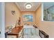 Bright bathroom showcasing a soaking tub with marble surround and elegant decor at 1710 New Bedford Dr, Sun City Center, FL 33573
