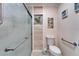 Tiled bathroom area showcasing walk-in shower, comfort height toilet, and safety bars at 1710 New Bedford Dr, Sun City Center, FL 33573