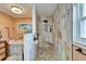 Contemporary shower featuring marble tiling, pebble flooring, and built-in bench seating at 1710 New Bedford Dr, Sun City Center, FL 33573