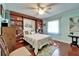 Comfortable bedroom features custom built-ins, light blue walls, and hardwood floors at 1710 New Bedford Dr, Sun City Center, FL 33573