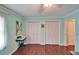 Bright bedroom featuring two closets, crown molding, and a calming color scheme at 1710 New Bedford Dr, Sun City Center, FL 33573