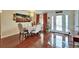 Cozy dining room with elegant chandelier, stylish furnishings, and beautiful hard wood flooring at 1710 New Bedford Dr, Sun City Center, FL 33573