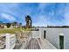 Dock with chairs overlooking the water, providing a perfect spot to relax and enjoy the scenery at 1710 New Bedford Dr, Sun City Center, FL 33573
