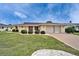 Beautiful home featuring lush landscaping, mature trees, and a two-car garage providing ample parking space at 1710 New Bedford Dr, Sun City Center, FL 33573