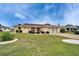 Well-manicured front yard complements this charming single-story home with a two-car garage at 1710 New Bedford Dr, Sun City Center, FL 33573