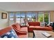 Light filled Florida room with sliding glass doors leading to outdoor seating area and serene water view at 1710 New Bedford Dr, Sun City Center, FL 33573