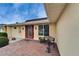 Charming front entry with brickwork, decorative door, manicured shrubs, and an inviting bench at 1710 New Bedford Dr, Sun City Center, FL 33573