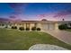 Inviting home with manicured lawn, updated features, and a warm ambiance at dusk at 1710 New Bedford Dr, Sun City Center, FL 33573