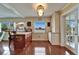 Kitchen bar area with custom cabinetry and seating, overlooking water views through large windows at 1710 New Bedford Dr, Sun City Center, FL 33573
