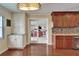 Eat-in kitchen features modern cabinets, granite countertops, stainless appliances, and pass-through to the sun-drenched Florida room at 1710 New Bedford Dr, Sun City Center, FL 33573