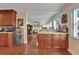 Kitchen featuring custom wood cabinets, granite countertops, and wine storage open to the living area at 1710 New Bedford Dr, Sun City Center, FL 33573