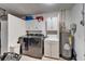 Functional laundry area with modern washer and dryer, sink, and overhead cabinets at 1710 New Bedford Dr, Sun City Center, FL 33573