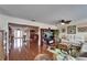 Bright living room featuring wood floors, large windows, and open floor plan with an entertainment center at 1710 New Bedford Dr, Sun City Center, FL 33573