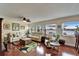 Living room featuring wood floors, large windows with water views, and comfortable seating at 1710 New Bedford Dr, Sun City Center, FL 33573