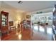 Bright living room with hardwood floors, a piano, water views, and comfortable seating at 1710 New Bedford Dr, Sun City Center, FL 33573