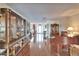 Large living area with hardwood floors, built-in shelving, and an open layout leading to the dining room at 1710 New Bedford Dr, Sun City Center, FL 33573
