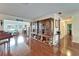Spacious living area featuring hardwood floors, built-in shelving, and comfortable seating with a water view at 1710 New Bedford Dr, Sun City Center, FL 33573