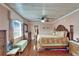 Spacious main bedroom has hardwood floors, ceiling fan and ensuite bathroom at 1710 New Bedford Dr, Sun City Center, FL 33573