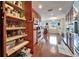 Pantry featuring custom wood cabinetry and pull out shelving system, for easy access and storage at 1710 New Bedford Dr, Sun City Center, FL 33573