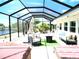 This screened patio features ample space for dining and lounging, complete with a fire pit and hot tub at 1710 New Bedford Dr, Sun City Center, FL 33573