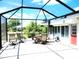 Spacious screened patio with comfortable seating area, perfect for relaxing and enjoying the outdoors at 1710 New Bedford Dr, Sun City Center, FL 33573