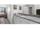 Bright bathroom featuring granite countertop vanity and a view into an adjacent bedroom at 18414 Malinche Loop, Spring Hill, FL 34610