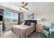 Comfortable bedroom featuring a ceiling fan, plush bedding, and bright window with natural light at 18414 Malinche Loop, Spring Hill, FL 34610