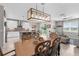 Dining area showcasing an open layout with modern lighting, seamlessly connected to the living room and kitchen at 18414 Malinche Loop, Spring Hill, FL 34610
