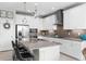 Modern kitchen featuring white cabinetry, stainless steel appliances, granite countertops, and an island with seating at 18414 Malinche Loop, Spring Hill, FL 34610
