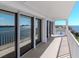 Balcony of a condo with sliding doors offering city and ocean views with a white railing at 2 Adalia Ave # 601, Tampa, FL 33606