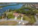 Stunning aerial view of a home with a tile roof, lush landscaping, and waterfront access at 2005 N Pointe Alexis Dr, Tarpon Springs, FL 34689