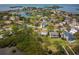 Aerial view of the property in a serene, waterfront setting surrounded by mature trees and lush greenery at 2005 N Pointe Alexis Dr, Tarpon Springs, FL 34689