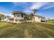 Charming home with a stucco exterior, tile roof, well-manicured lawn, and inviting deck area at 2005 N Pointe Alexis Dr, Tarpon Springs, FL 34689