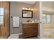 Bathroom showcasing a granite vanity, framed mirror, and access to a tiled stand up shower at 2005 N Pointe Alexis Dr, Tarpon Springs, FL 34689