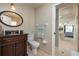 Elegant bathroom featuring a dark wood vanity, granite countertop, and neutral tile at 2005 N Pointe Alexis Dr, Tarpon Springs, FL 34689