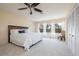 Spacious bedroom features a white bed, ceiling fan, and large windows providing ample natural light at 2005 N Pointe Alexis Dr, Tarpon Springs, FL 34689
