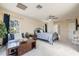 Cozy bedroom featuring a bed, a ceiling fan, a seating area and large windows with view at 2005 N Pointe Alexis Dr, Tarpon Springs, FL 34689
