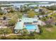 Stunning aerial view of the community center, pool, and tennis courts with lush landscaping, offering a resort-like experience at 2005 N Pointe Alexis Dr, Tarpon Springs, FL 34689