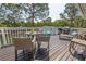 Wooden deck featuring table with chairs, lounge chair and a grill at 2005 N Pointe Alexis Dr, Tarpon Springs, FL 34689