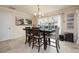 Bright dining room with view of pool, stylish table and chairs under a chandelier at 2005 N Pointe Alexis Dr, Tarpon Springs, FL 34689